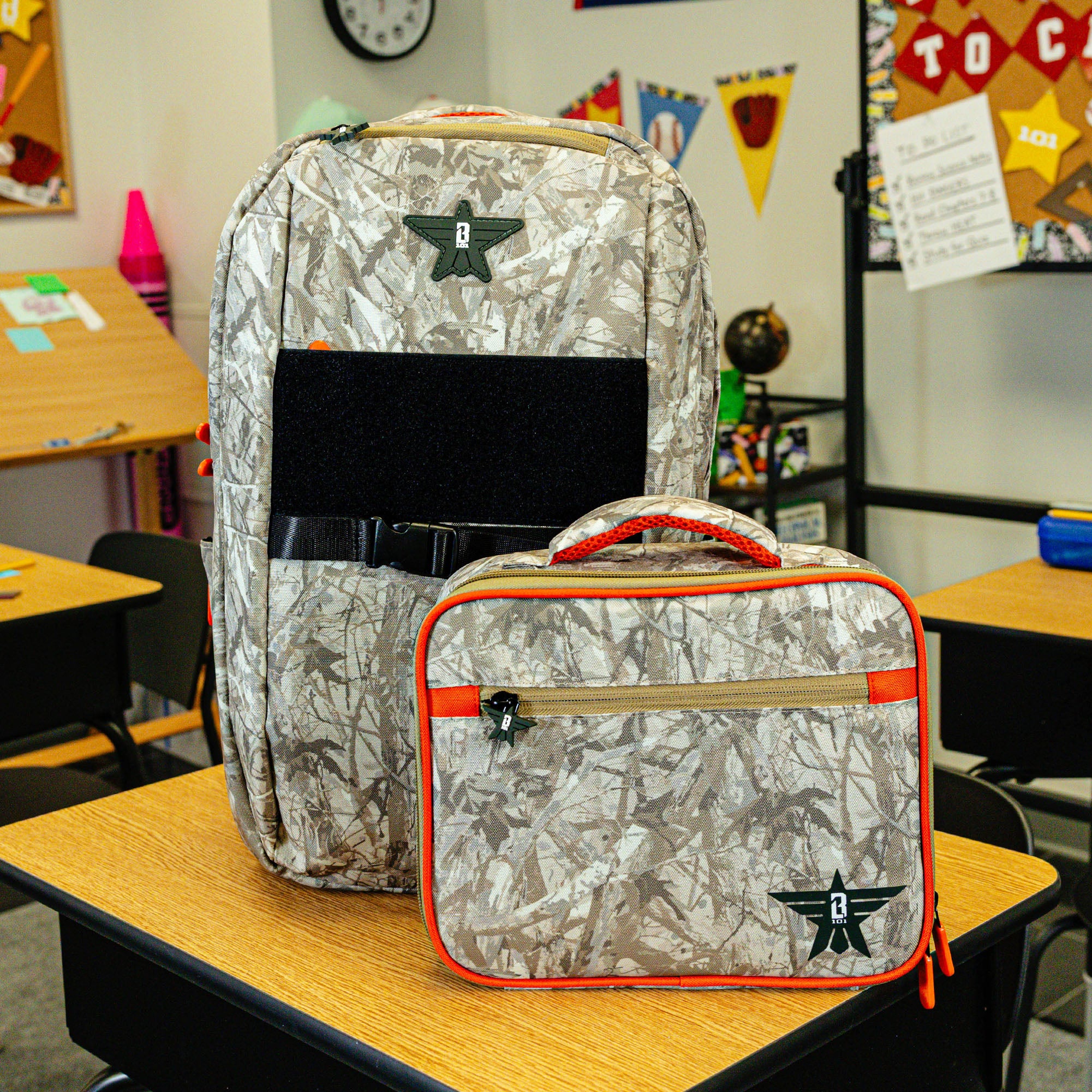 Adult model wearing multi-color lunch box with "Born To Fly SZN 2" design