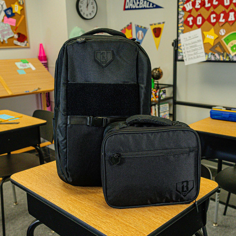 Adult model wearing black lunch box with "SZN 2" design