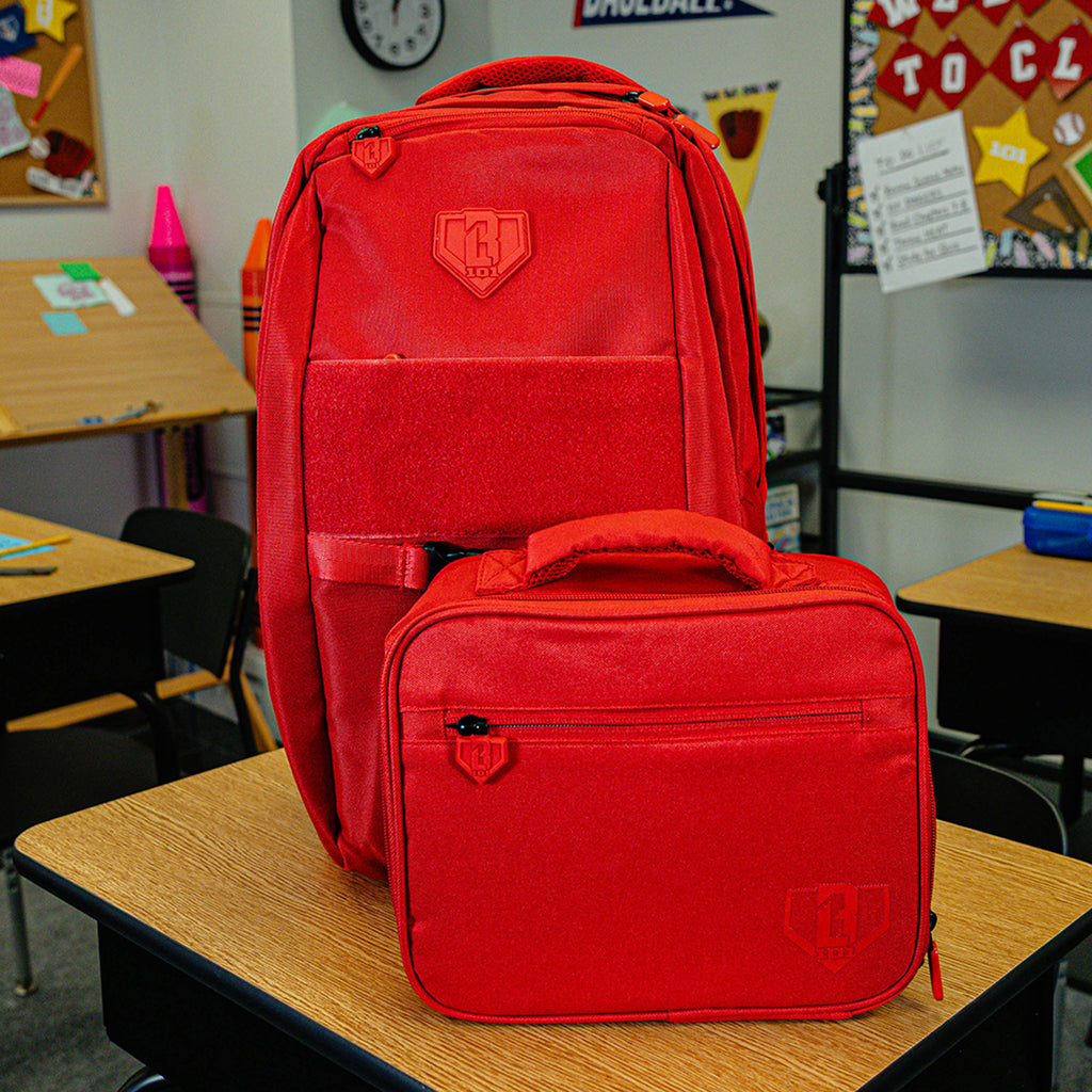 Adult model wearing red lunch box with "SZN 2" design