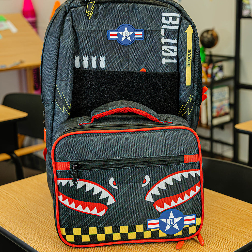 Adult model wearing multi-color lunch box with "Unit 101 SZN 2" design