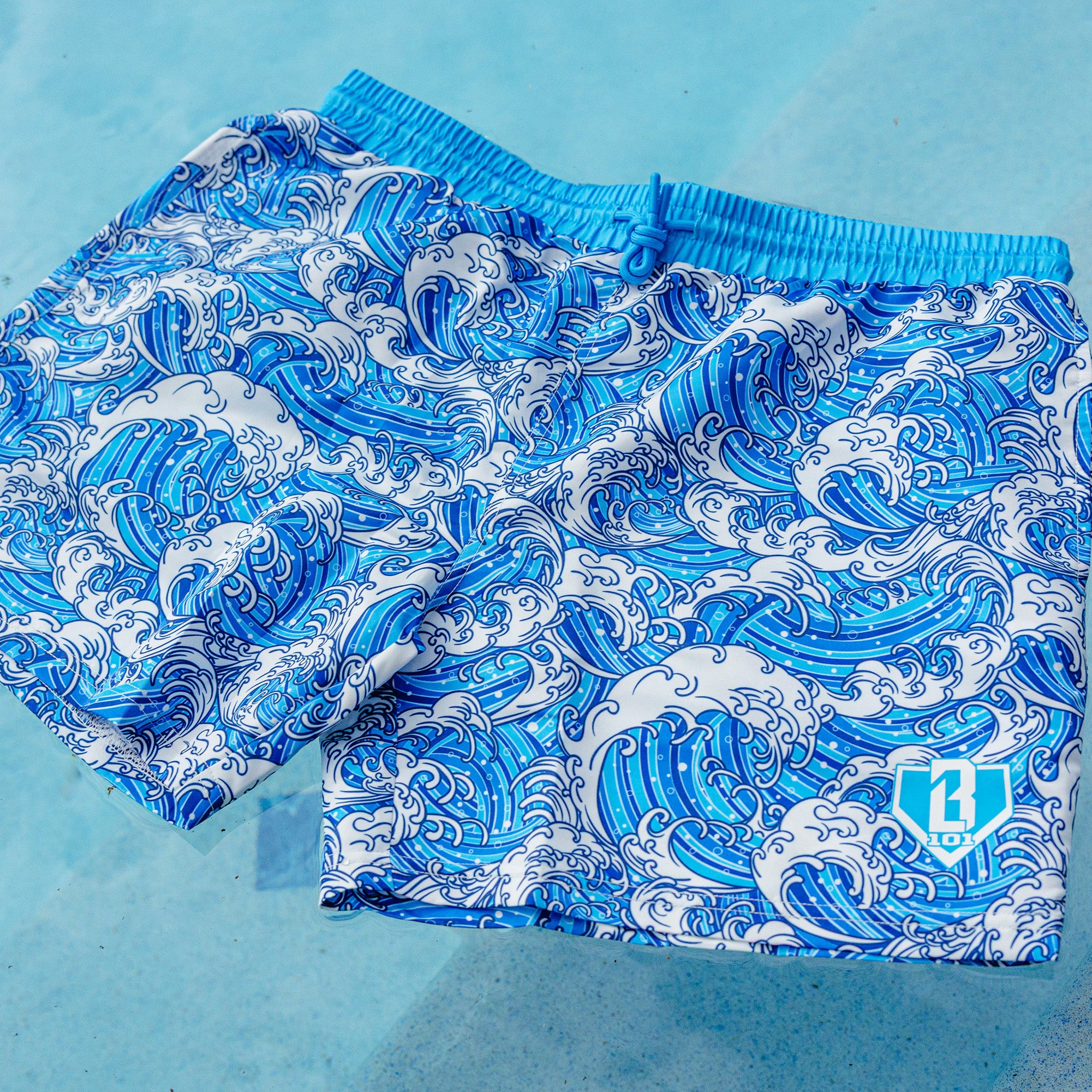 Blue and white wave patterned shorts on a white background