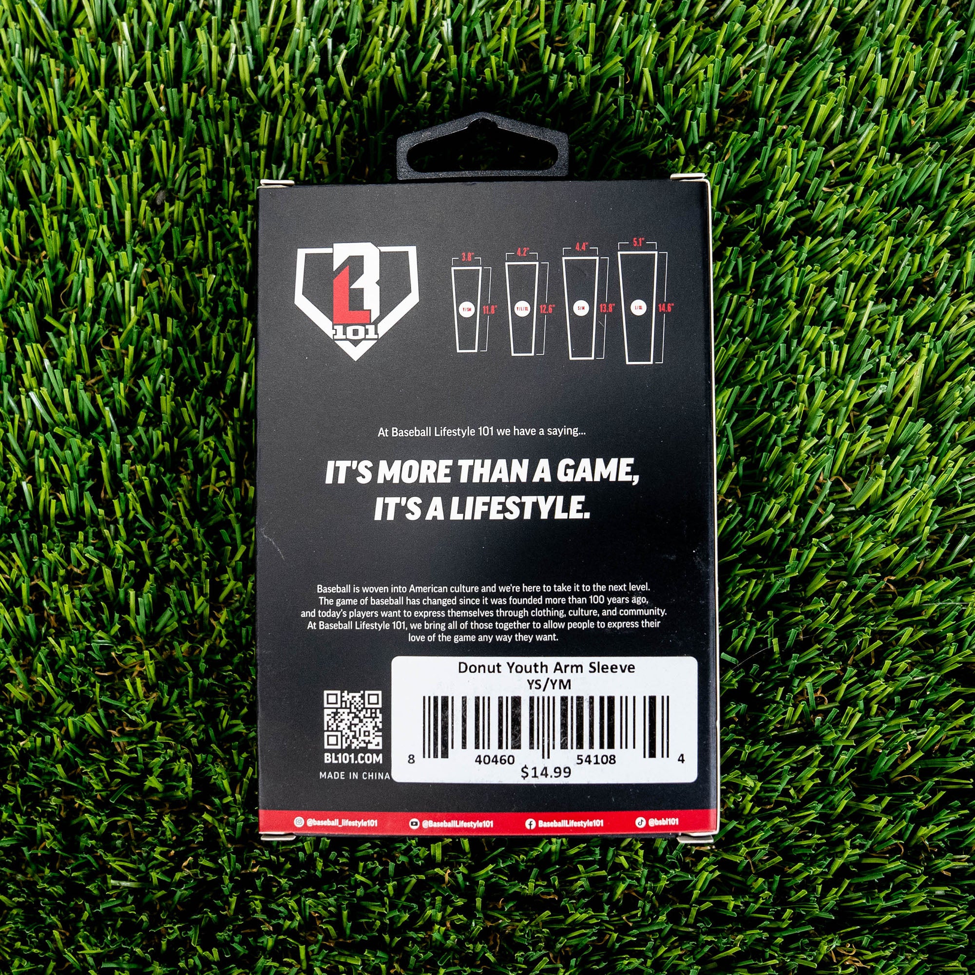 Back of the BL101 arm sleeve retail box on green turf showing size chart brand tagline and Donut Youth Arm Sleeve barcode label priced at 14.99