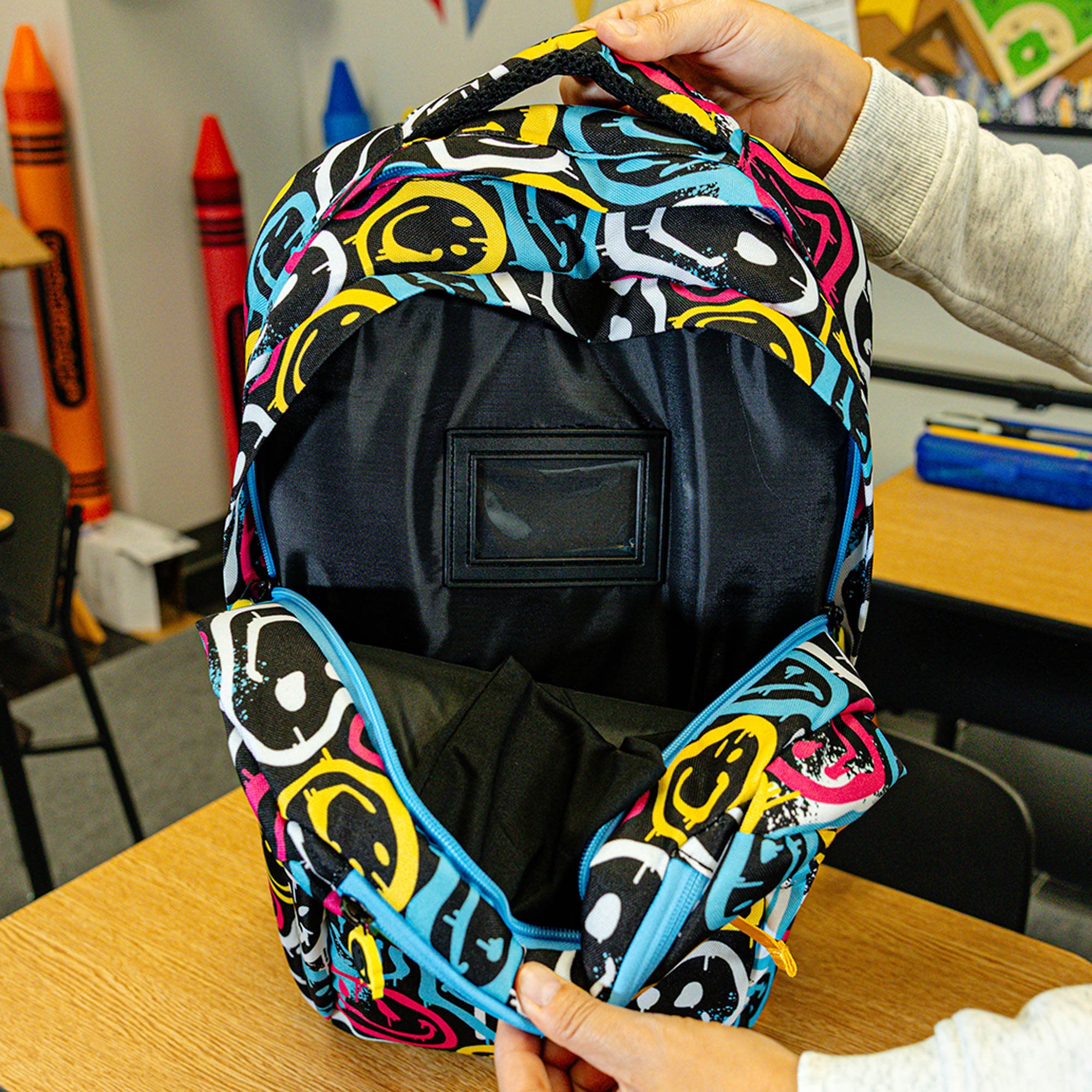 Multi-Color backpack with "Smiley Slugger SZN 2" design — back view