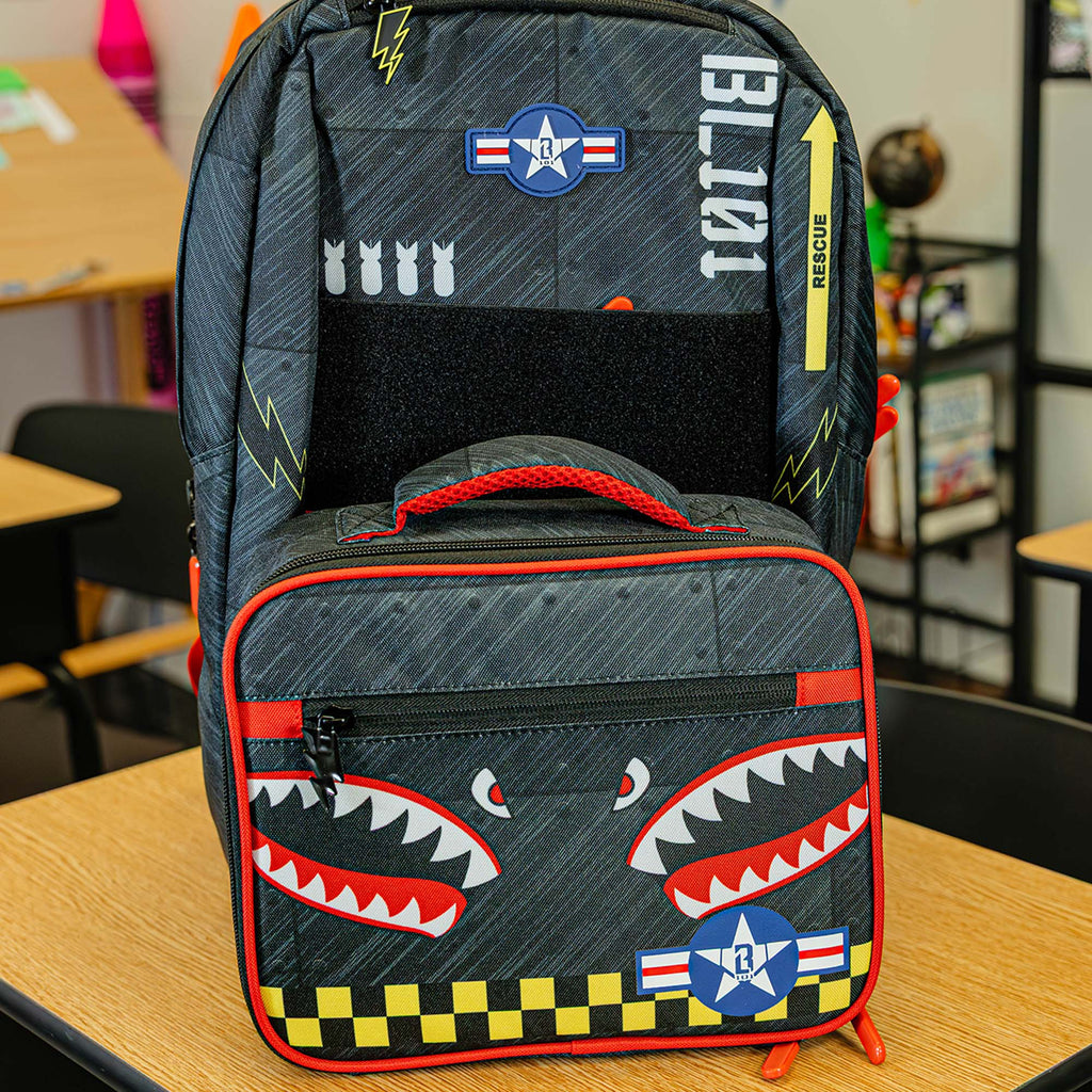 Adult model wearing multi-color backpack with "Unit 101 SZN 2" design
