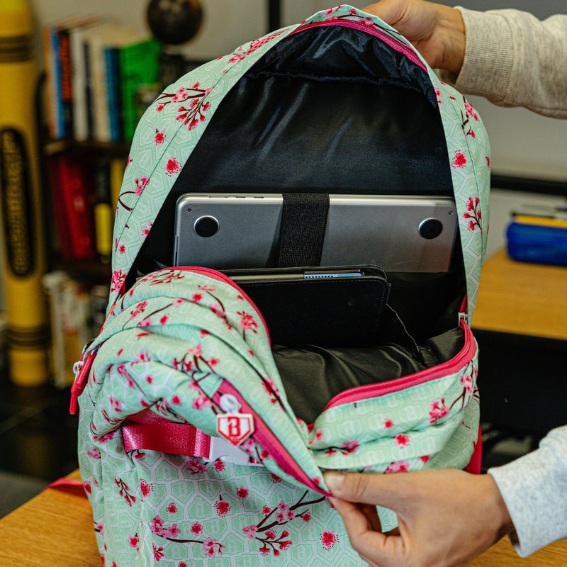 Green backpack with "Cherry Blossoms SZN 2" design — back view