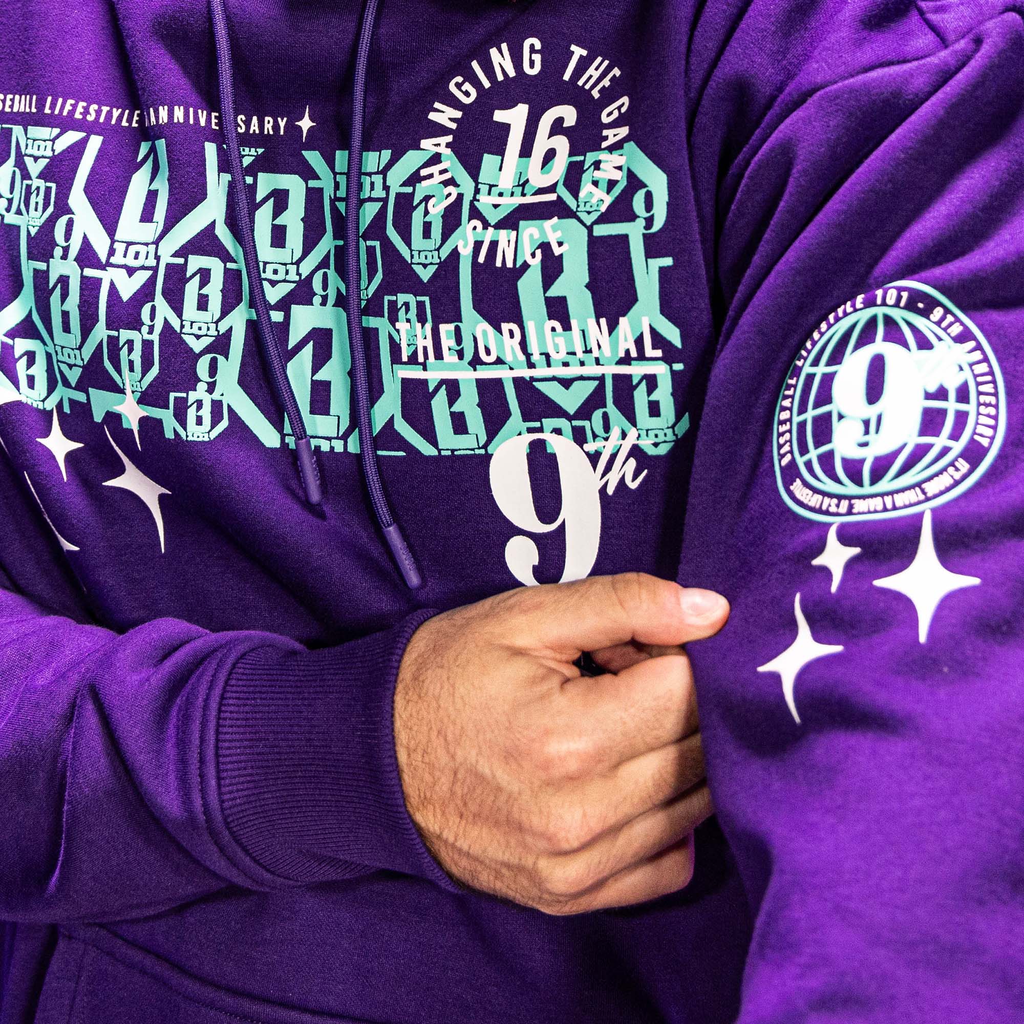 Close up of purple hoodie with blue BL101 9th anniversary graphic designs