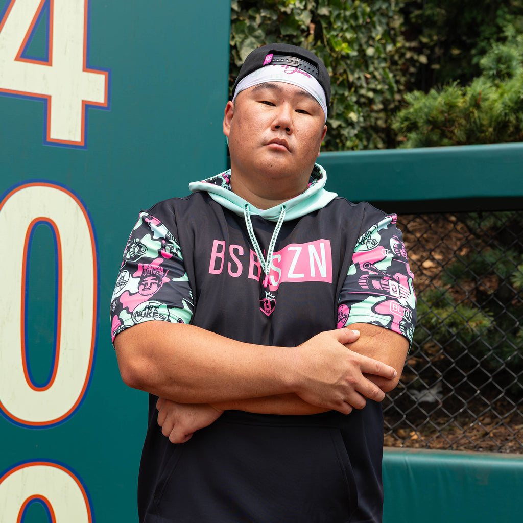 Adult model wearing white headband with "BL101 X Eric Sim" design