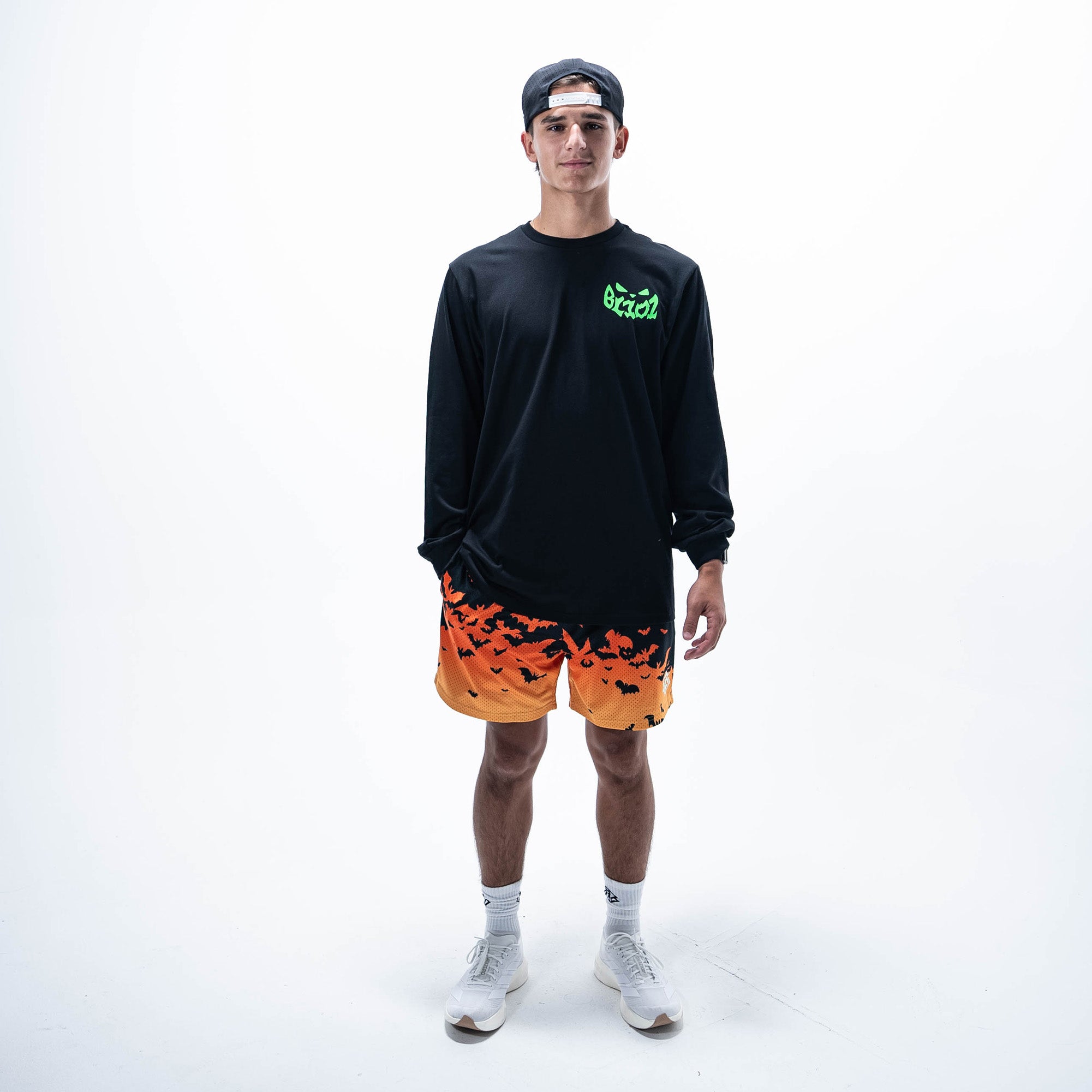 Adult model wearing orange shorts with "Bat Gradient" design