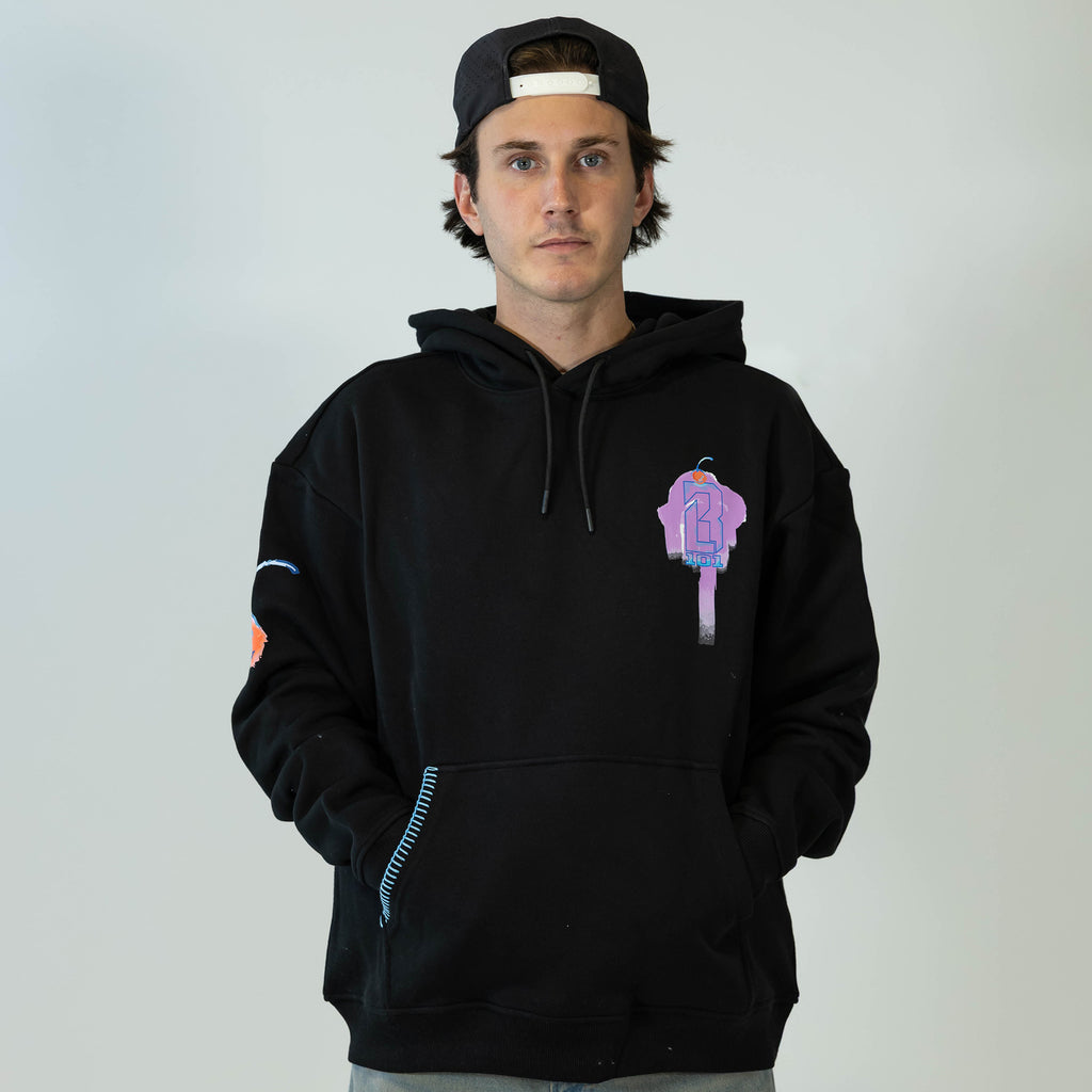 Adult model wearing black hoodie with "Fastball Scoops" design