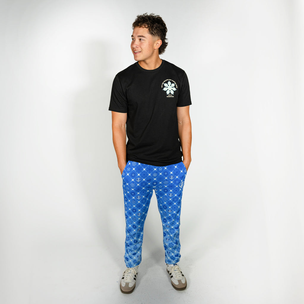 Adult model wearing blue pajama pants with "Frozen Diamond" design