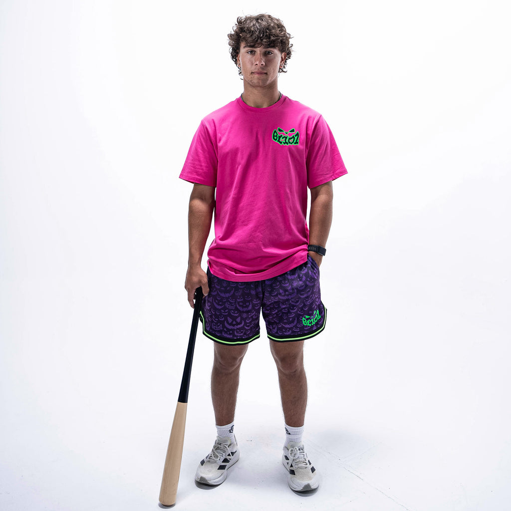 Adult model wearing purple shorts with "Jack O' Lantern Team" design