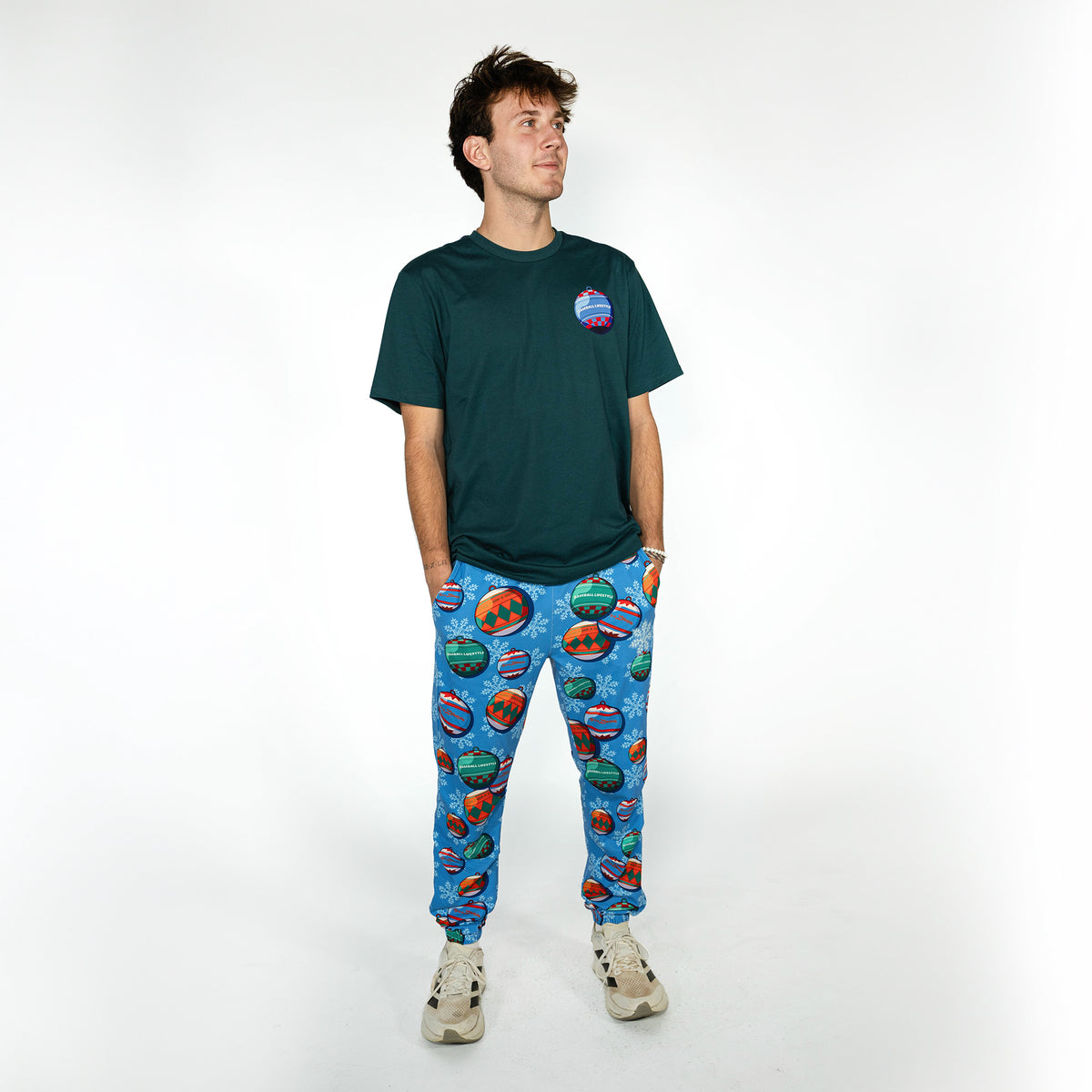 Adult model wearing blue pajama pants with "Jingle Ballers" design
