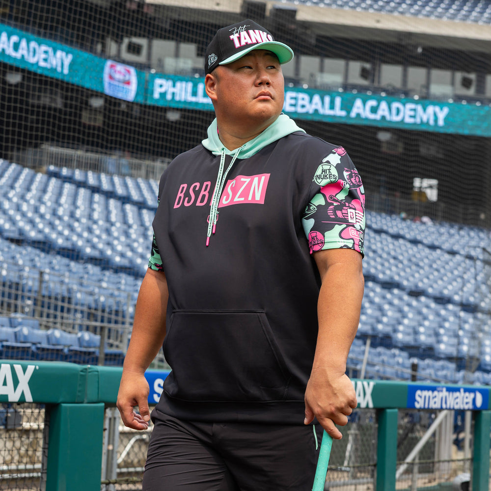 Adult model wearing black short sleeve hoodie with "King Of JUCO BSBL-SZN V3" design
