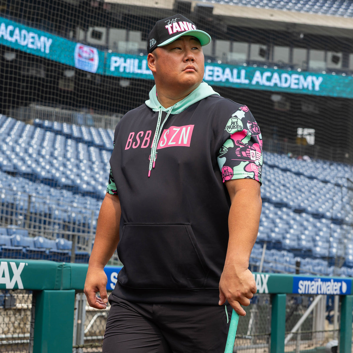 Adult model wearing black short sleeve hoodie with "King Of JUCO BSBL-SZN V3" design