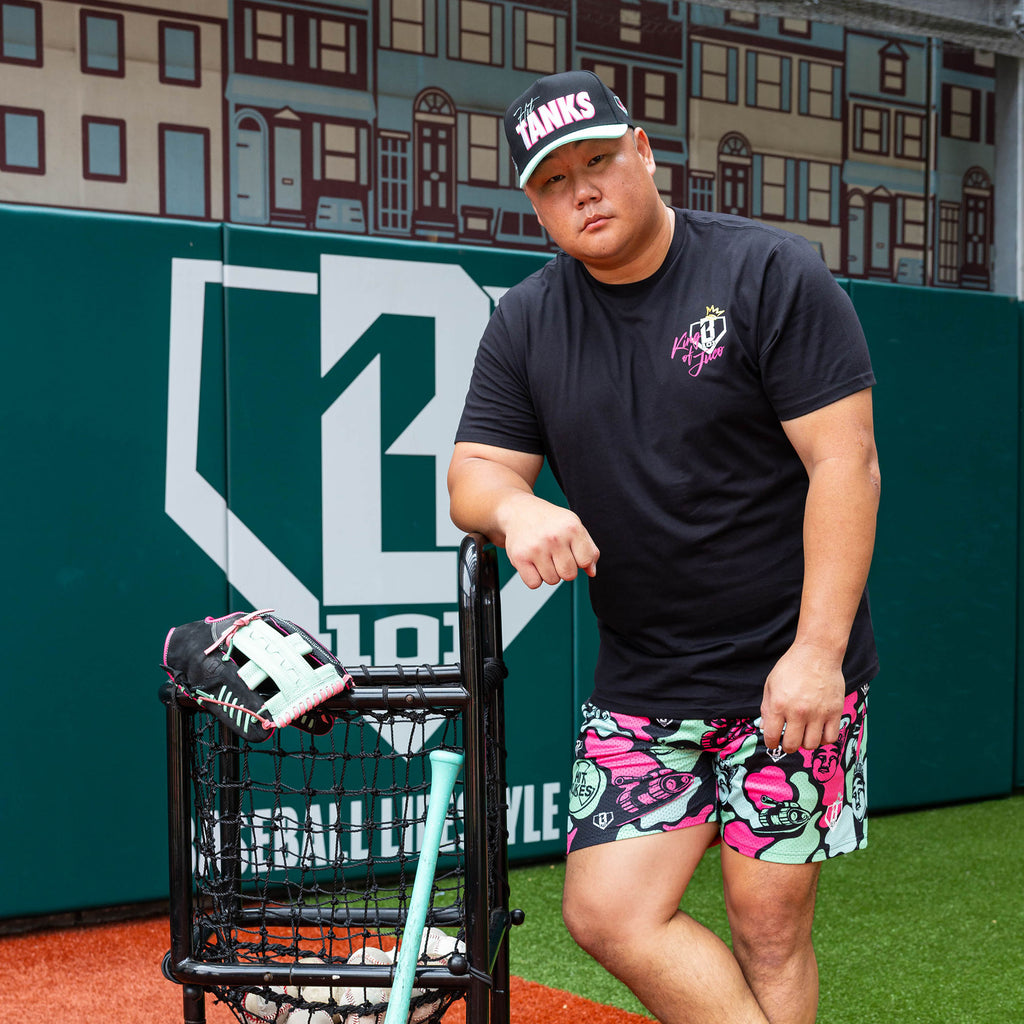 Adult model wearing black shorts with "King Of JUCO" design