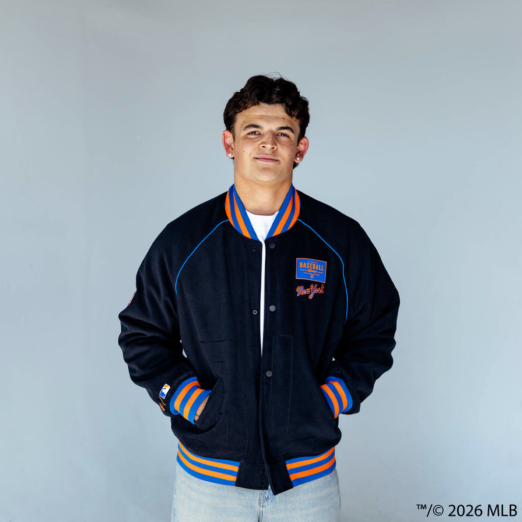Adult model wearing black New York Mets Stadium bomber jacket