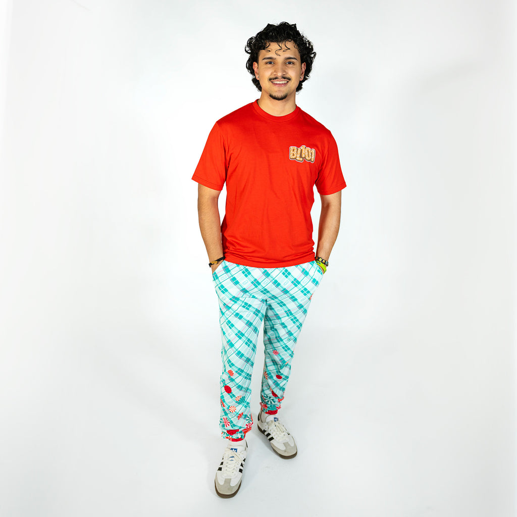 Adult model wearing multi-color pajama pants with "Peppermint Plaid" design