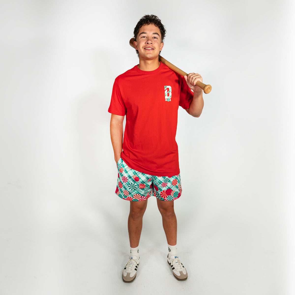 Adult model wearing teal shorts with "Peppermint Plaid" design