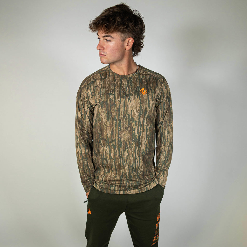 Adult model wearing multi-color Realtree Legacy Diamond Tech Camo long sleeve
