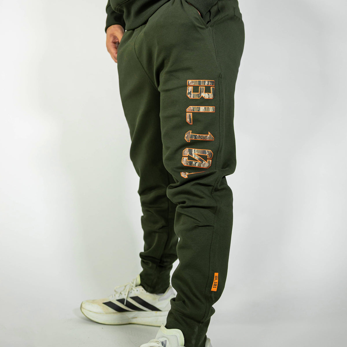 Adult model wearing green Realtree Legacy Diamond Relaxed Fit Camo joggers