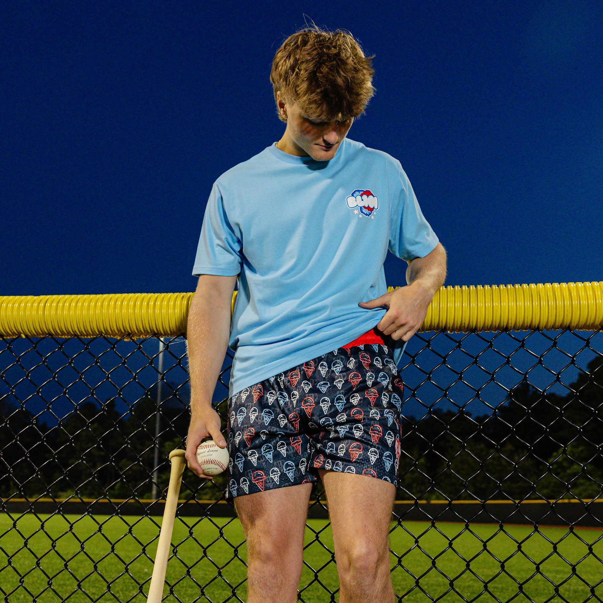 Adult model wearing red, white & blue Scoops Ice Cream shorts