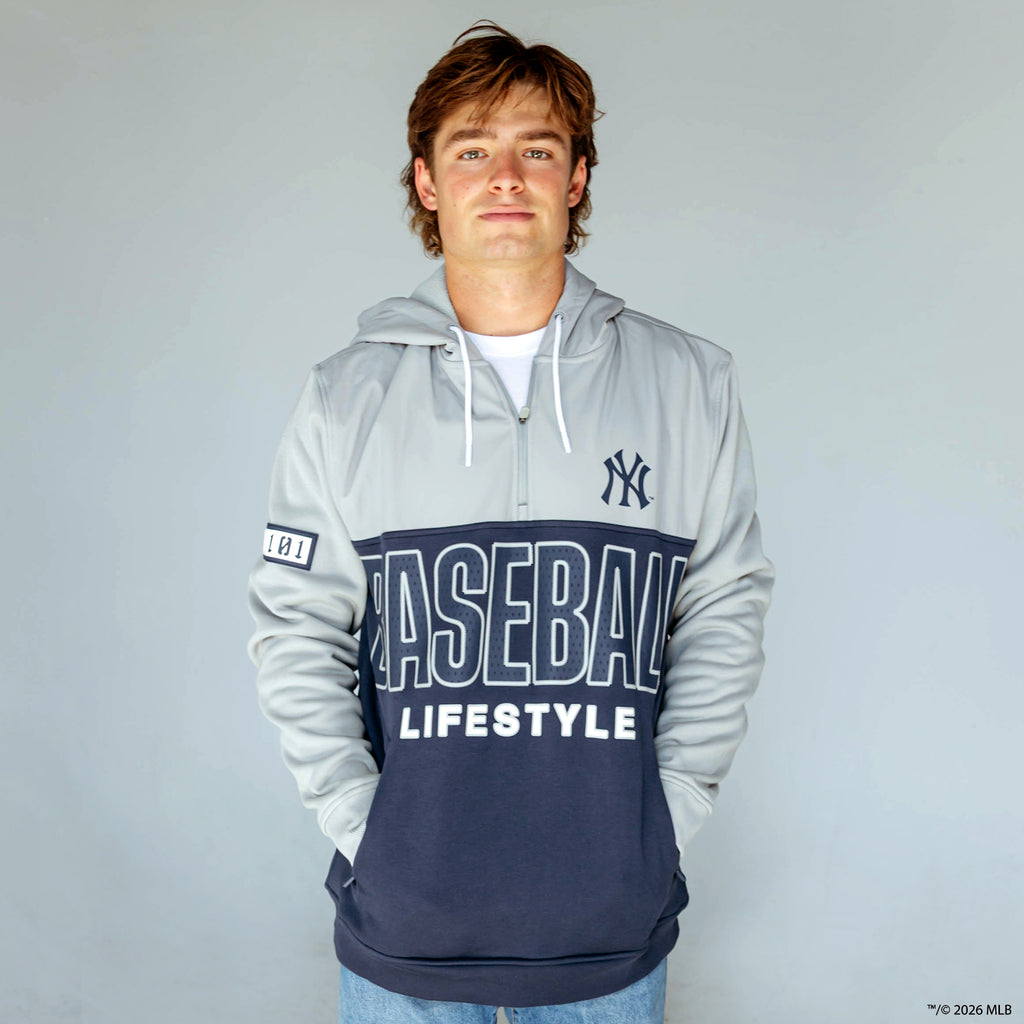 Adult model wearing navy New York Yankees Color Block quarter zip