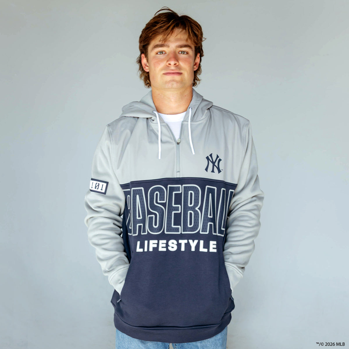 Adult model wearing navy New York Yankees Color Block quarter zip
