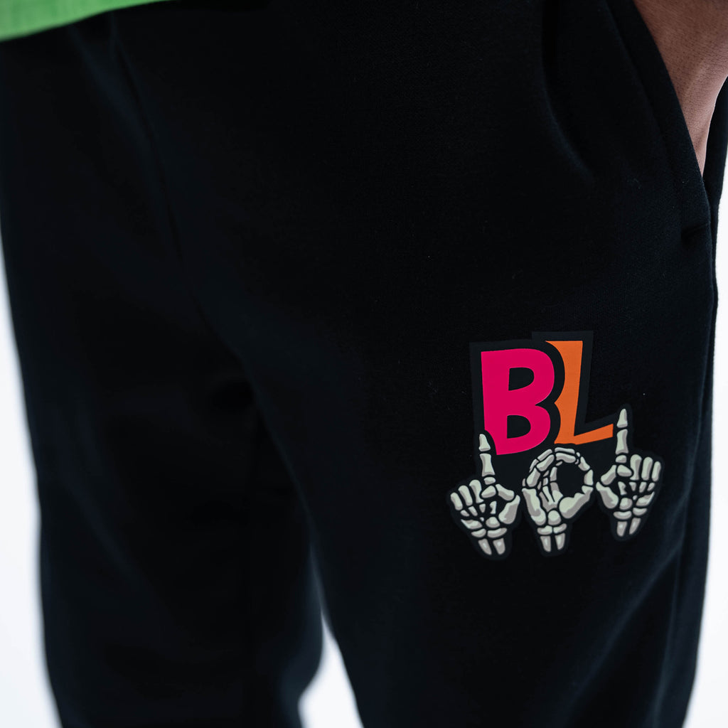 Adult model wearing black joggers with "101 Skeleton" design