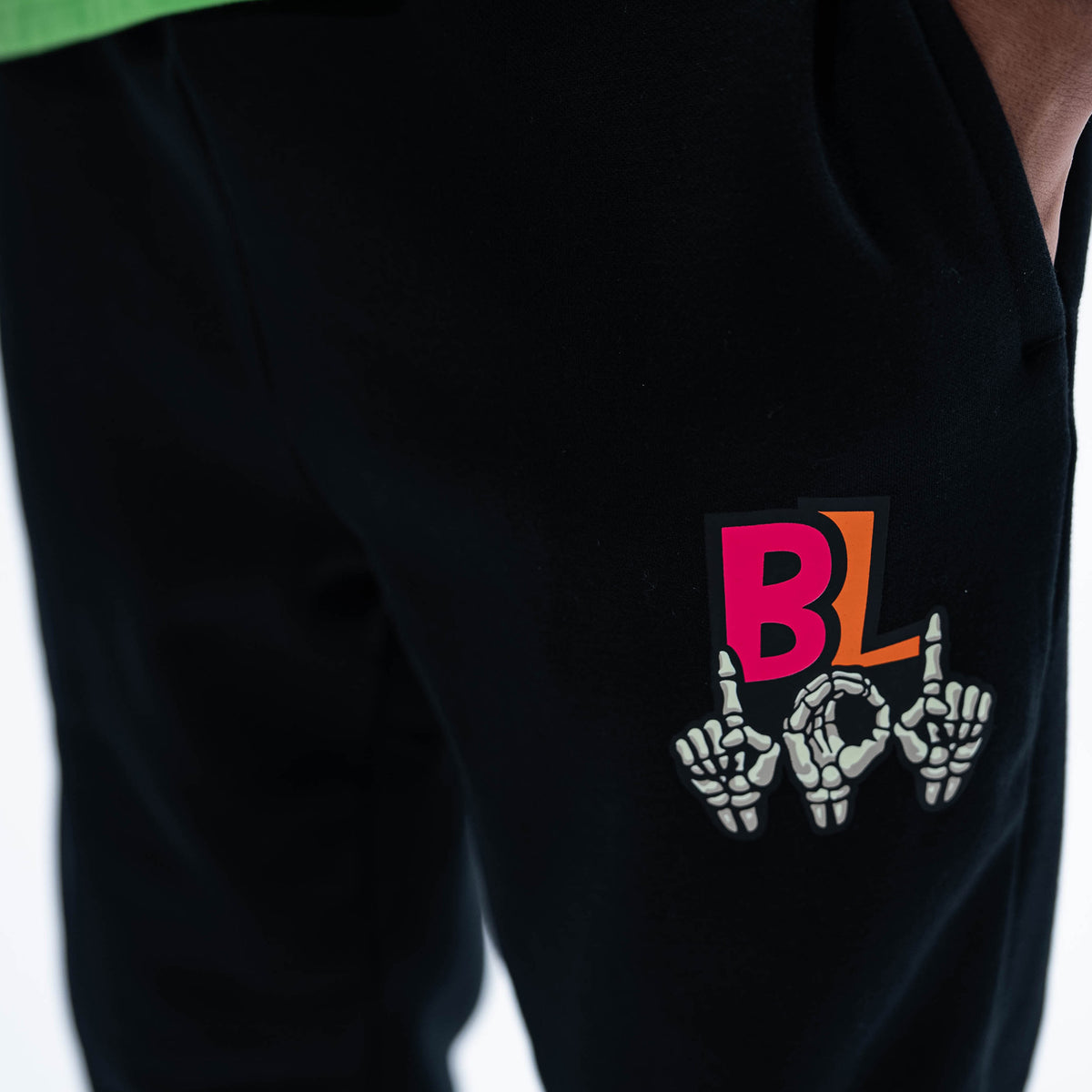 Adult model wearing black joggers with "101 Skeleton" design