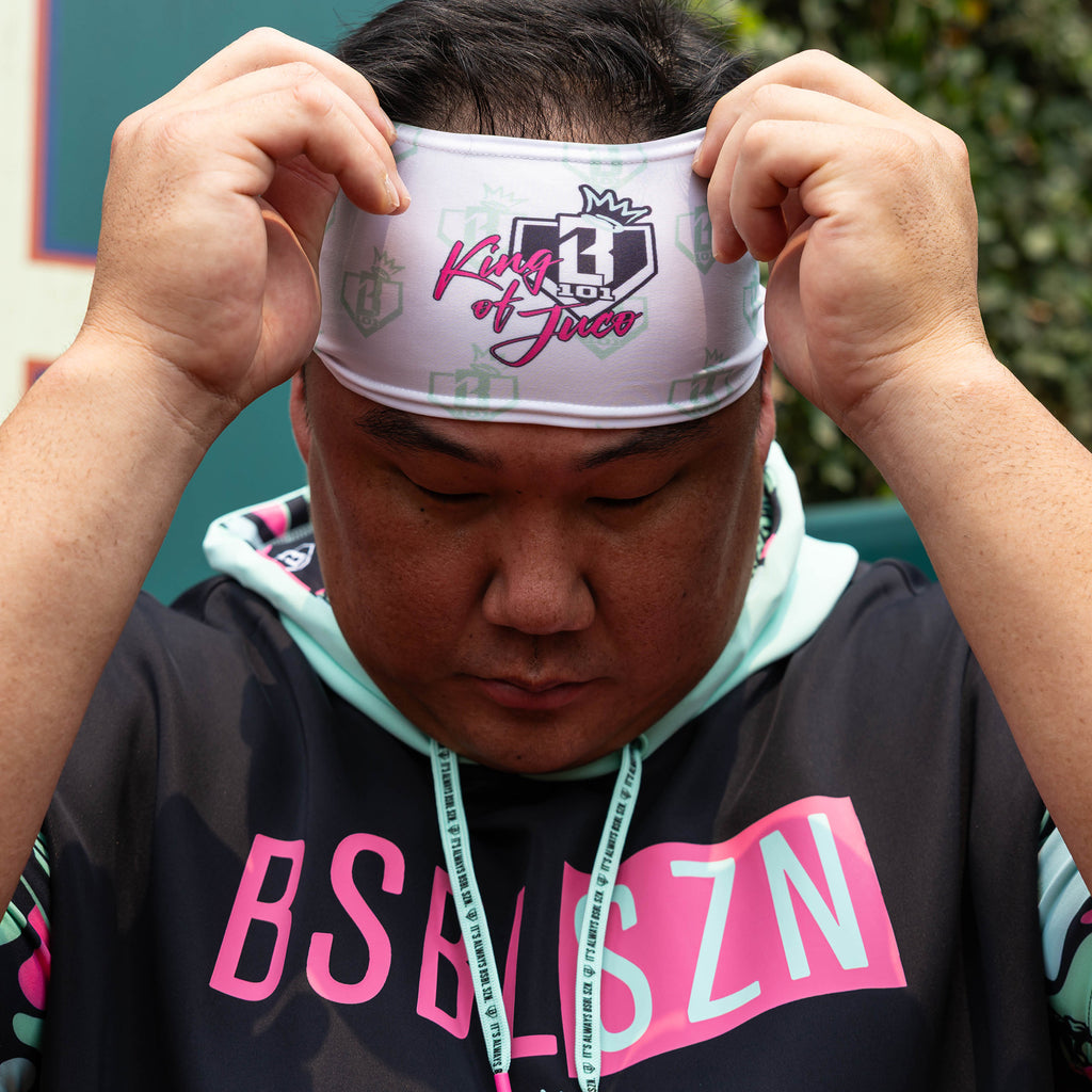 Adult model wearing white headband with "BL101 X Eric Sim" design