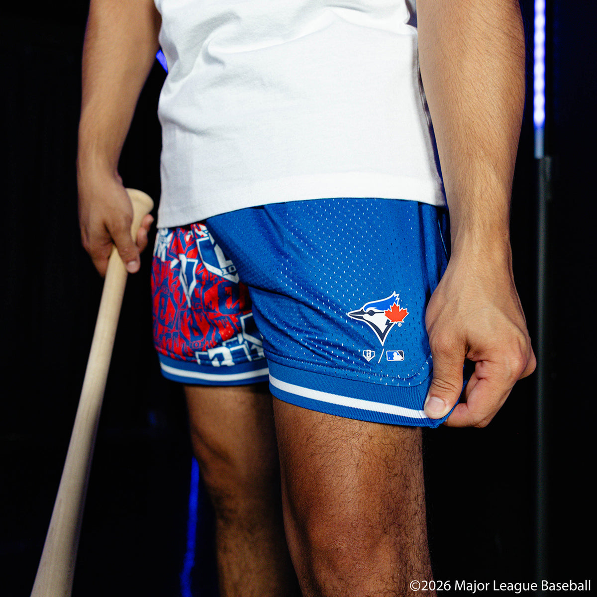 Adult model wearing blue shorts with "Toronto Blue Jays Sticker Court" design