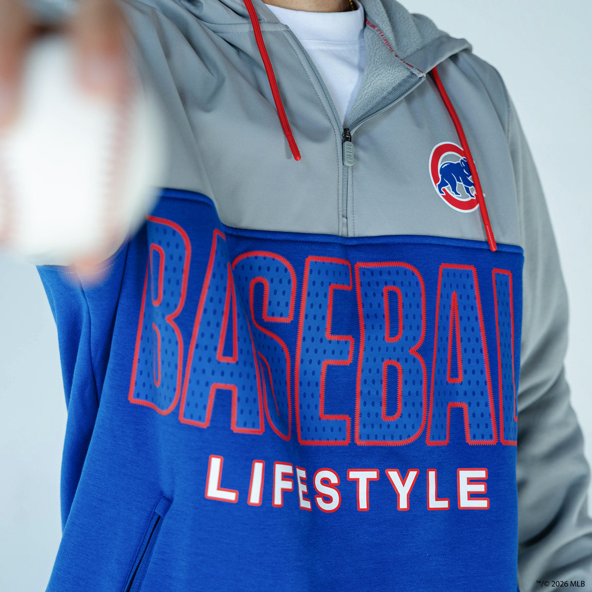 Adult model wearing blue Chicago Cubs Color Block quarter zip