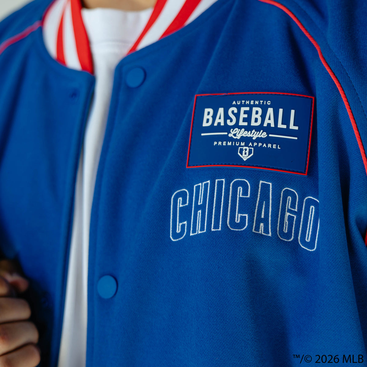 Adult model wearing blue Chicago Cubs Stadium bomber jacket