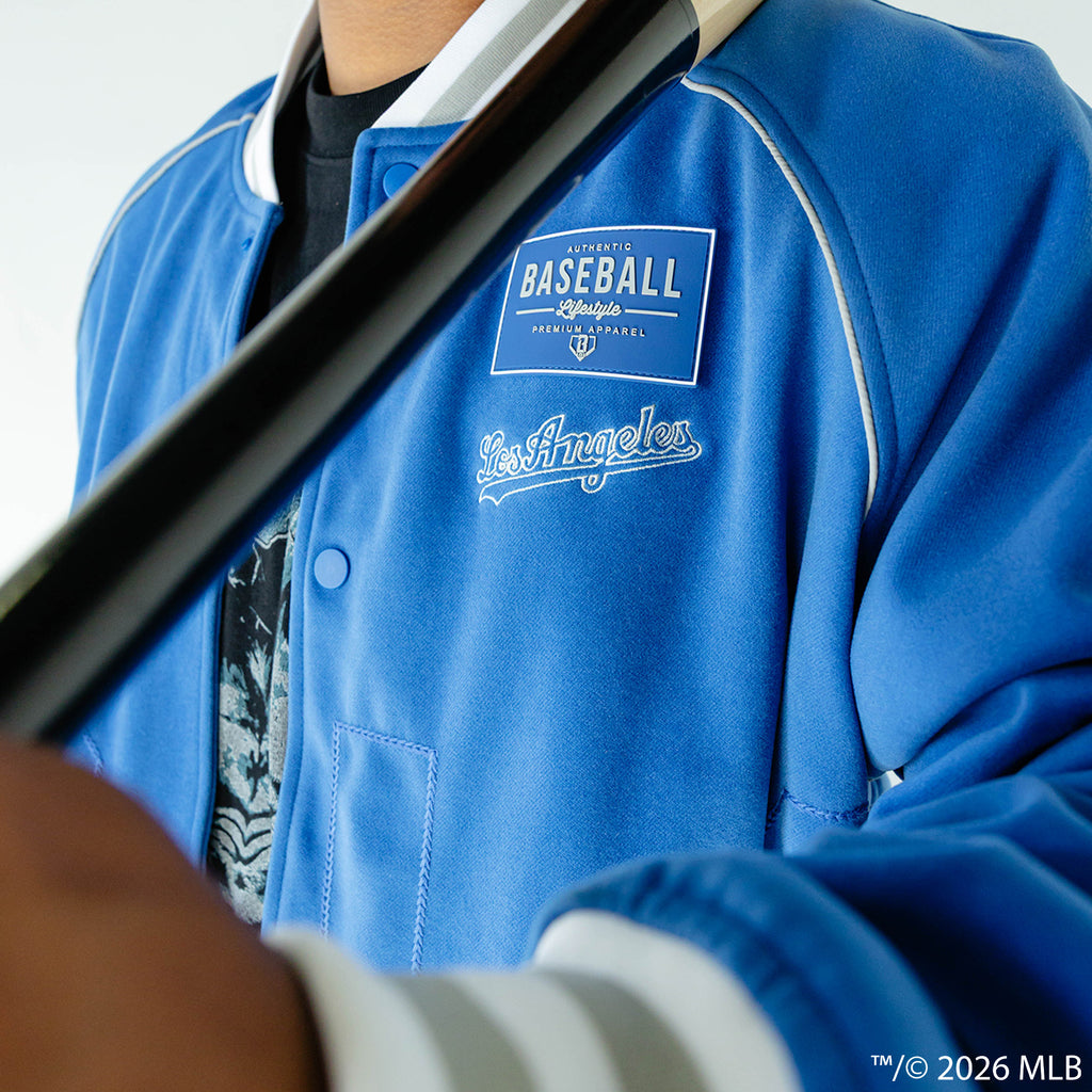 Adult model wearing blue Los Angeles Dodgers Stadium bomber jacket