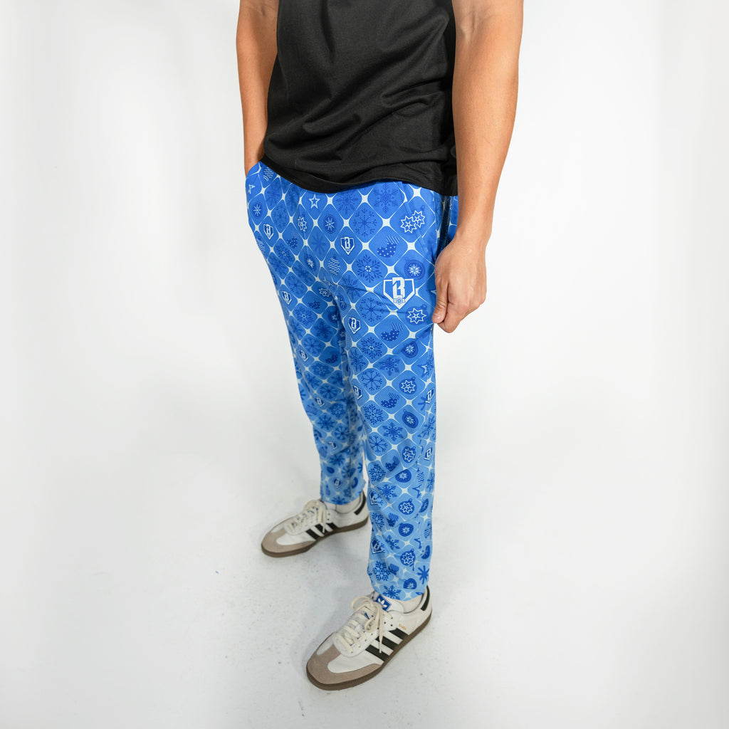 Adult model wearing blue pajama pants with "Frozen Diamond" design