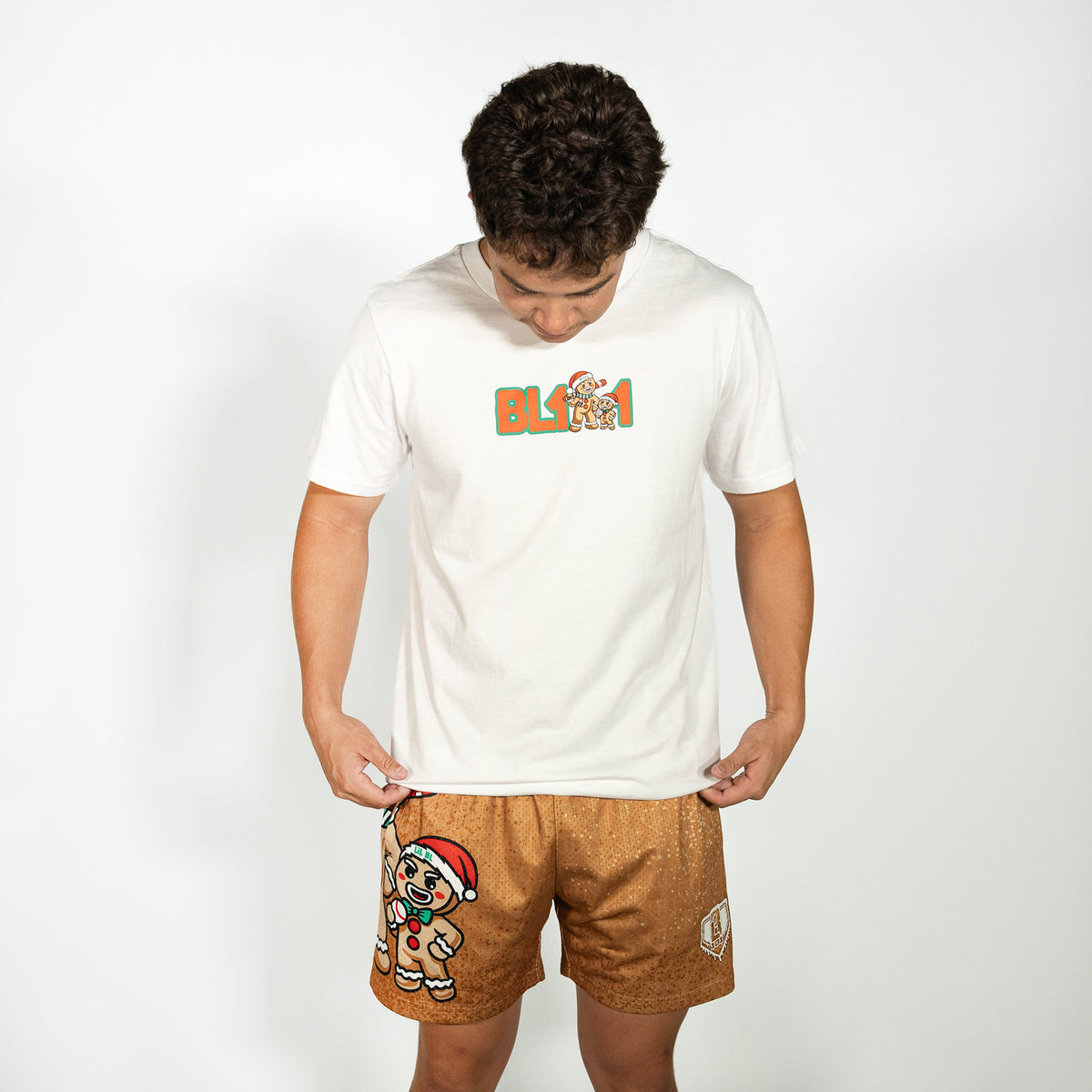 Adult model wearing brown shorts with "Gingerbread Rookie" design