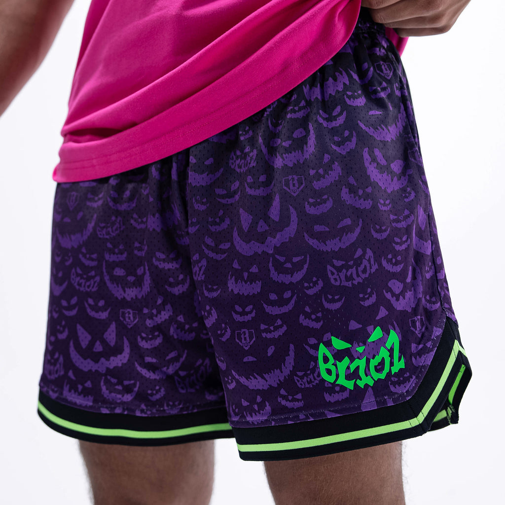 Adult model wearing purple shorts with "Jack O' Lantern Team" design