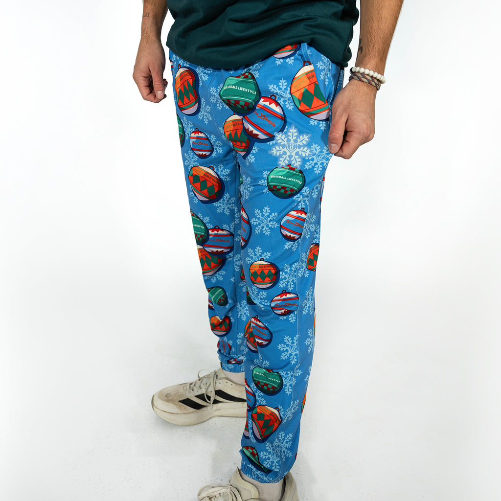 Adult model wearing blue pajama pants with "Jingle Ballers" design