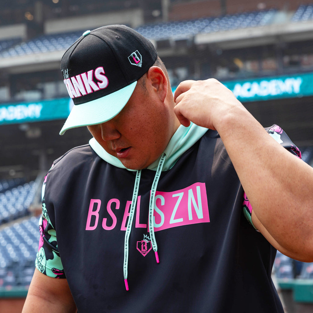 Adult model wearing black short sleeve hoodie with "King Of JUCO BSBL-SZN V3" design