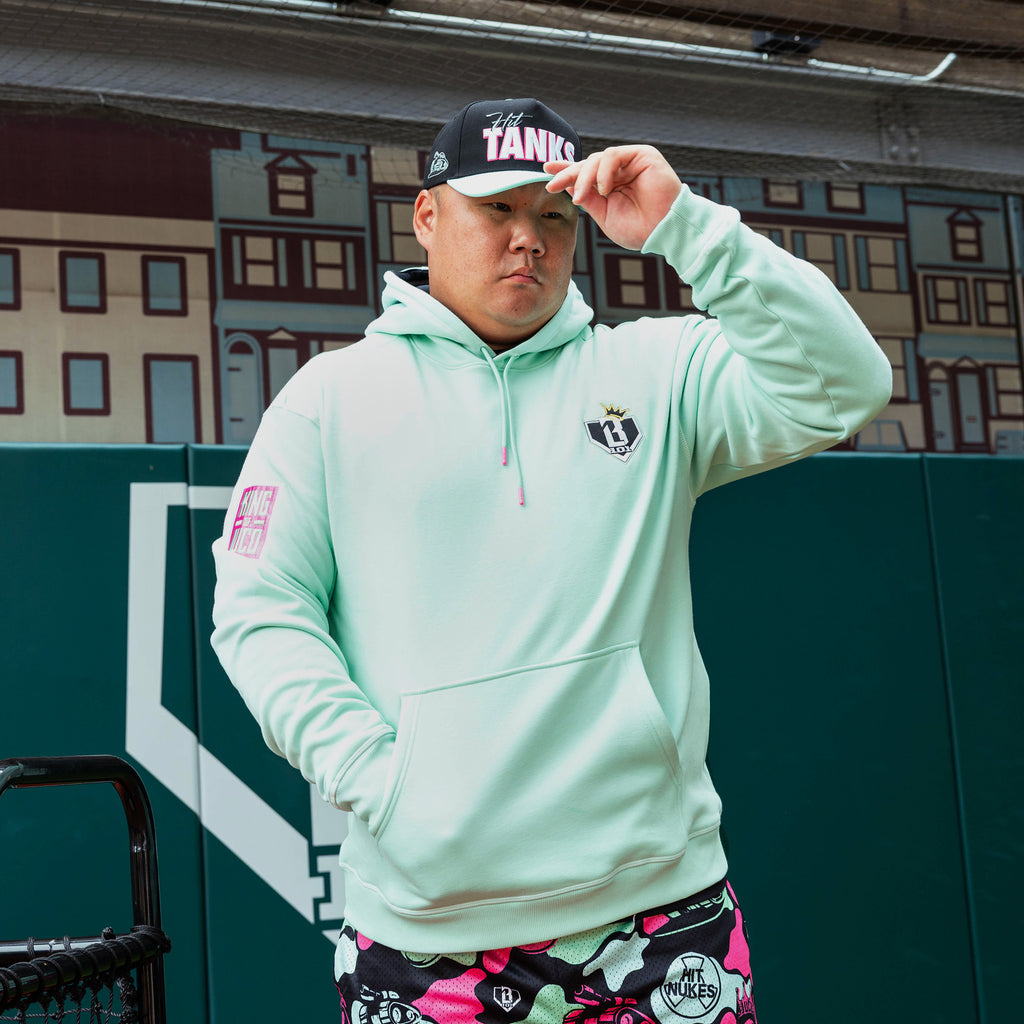 Adult model wearing teal hoodie with "King Of JUCO" design
