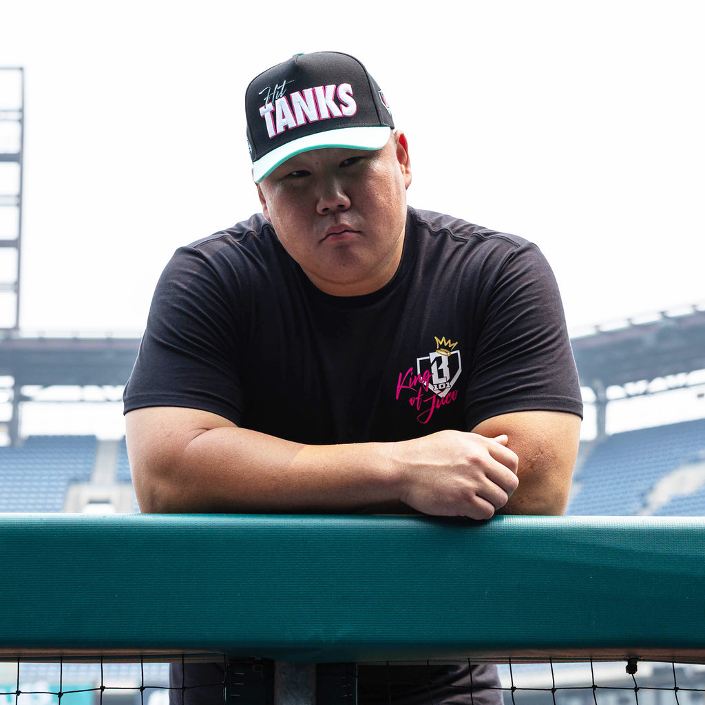 Adult model wearing black graphic tee with "King Of JUCO" design