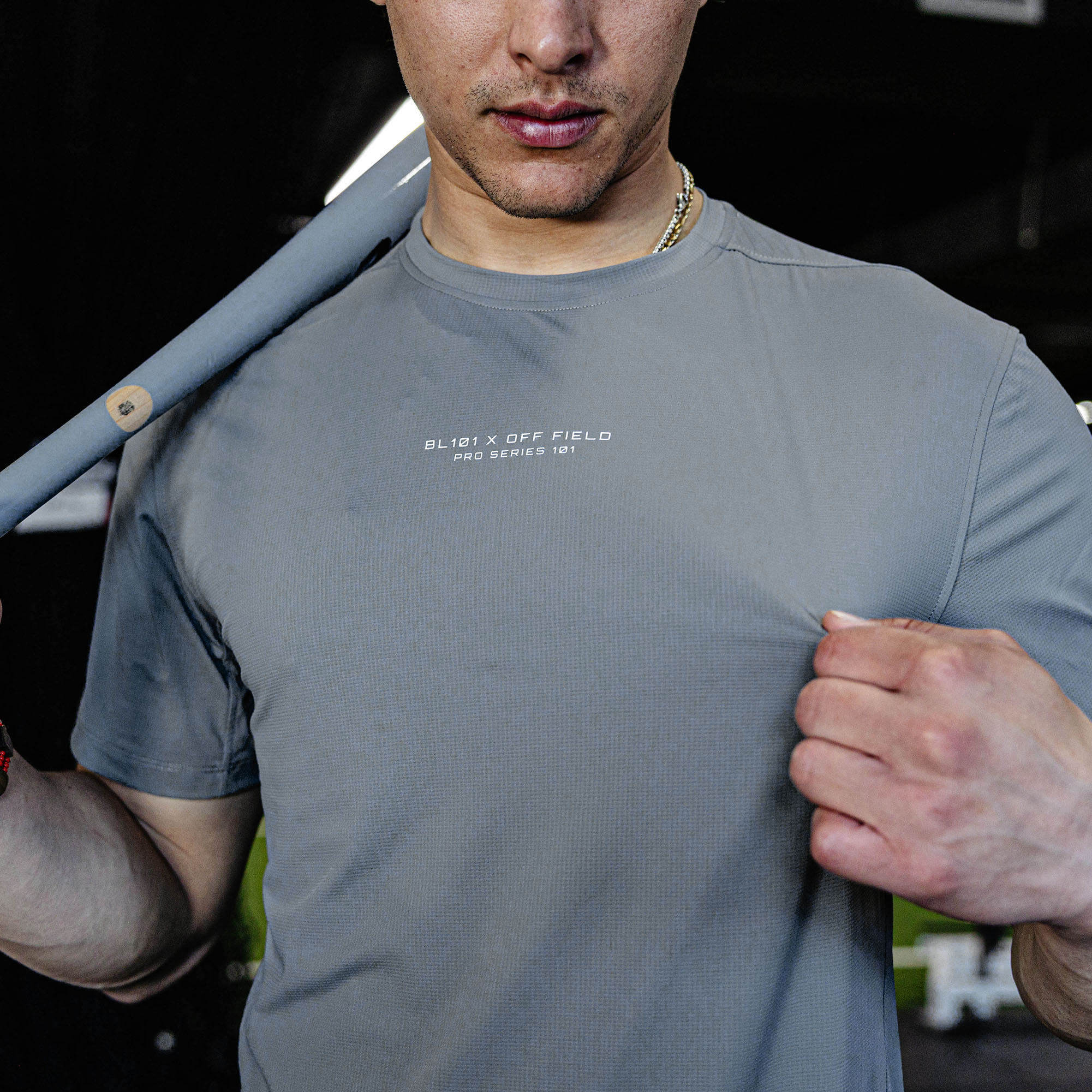 Man wearing a gray t-shirt with text.