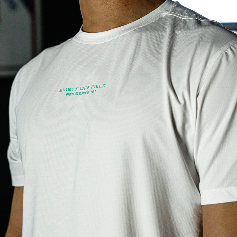 White t-shirt with text on the chest worn by a person, blurred background