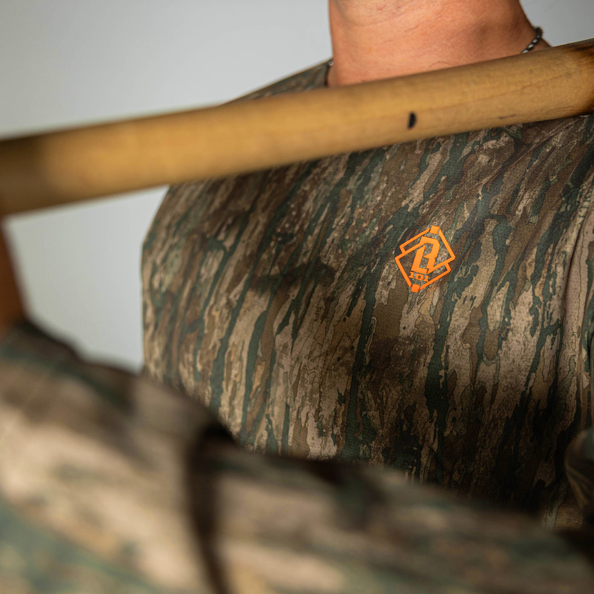 Adult model wearing multi-color Realtree Legacy Diamond Tech Camo long sleeve