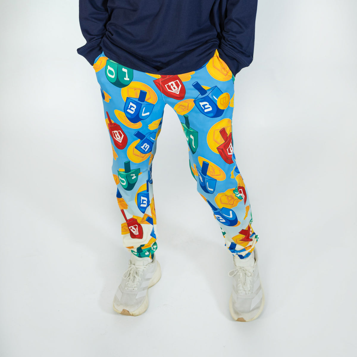 Adult model wearing blue pajama pants with "Spin & Swing" design