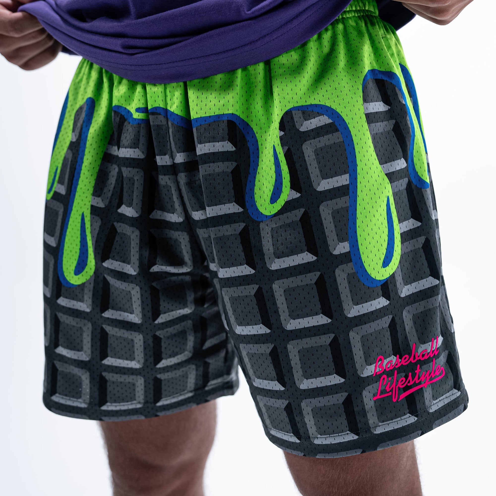 Adult model wearing black shorts with "Spooky SZN Waffle" design