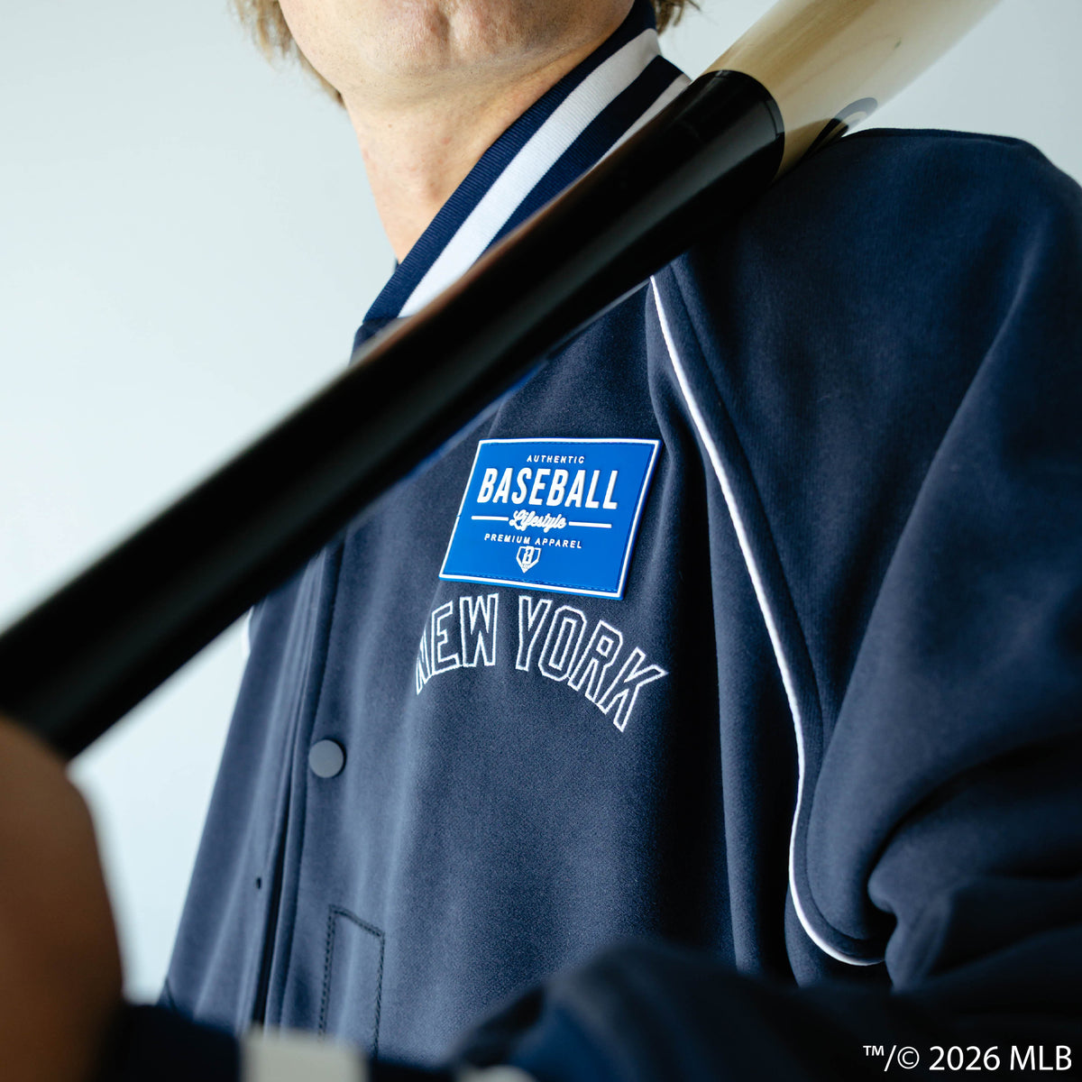 Adult model wearing navy New York Yankees Stadium bomber jacket