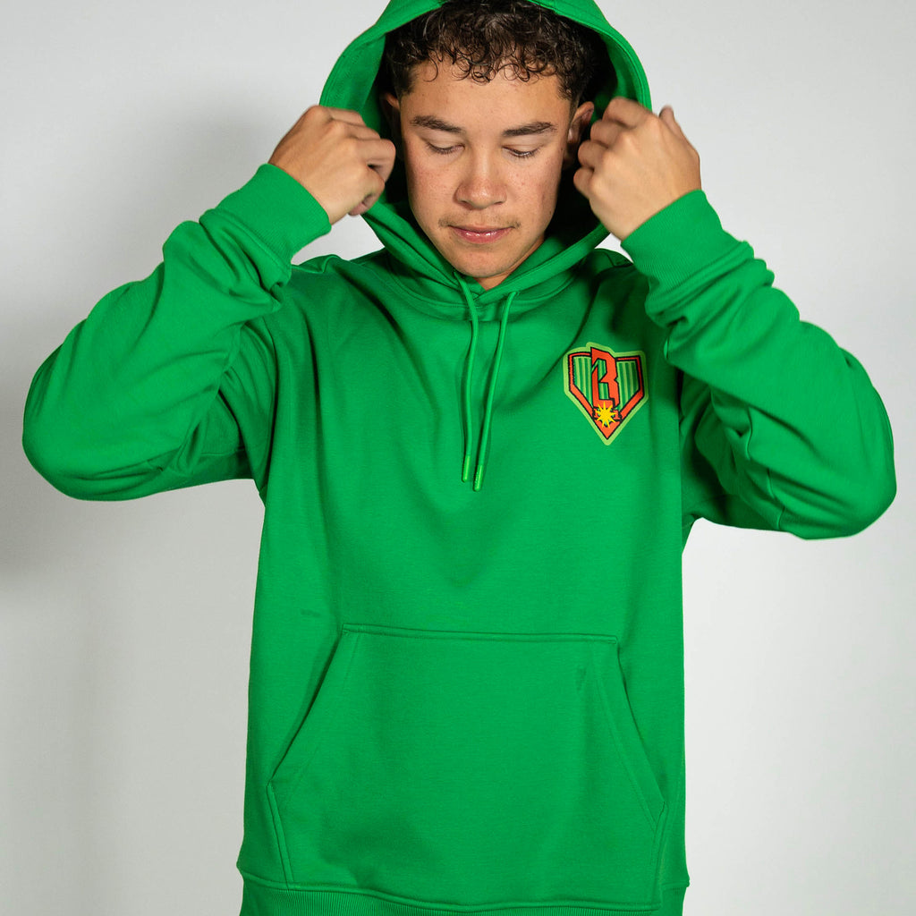 Adult model wearing green hoodie with "Tis The SZN" design