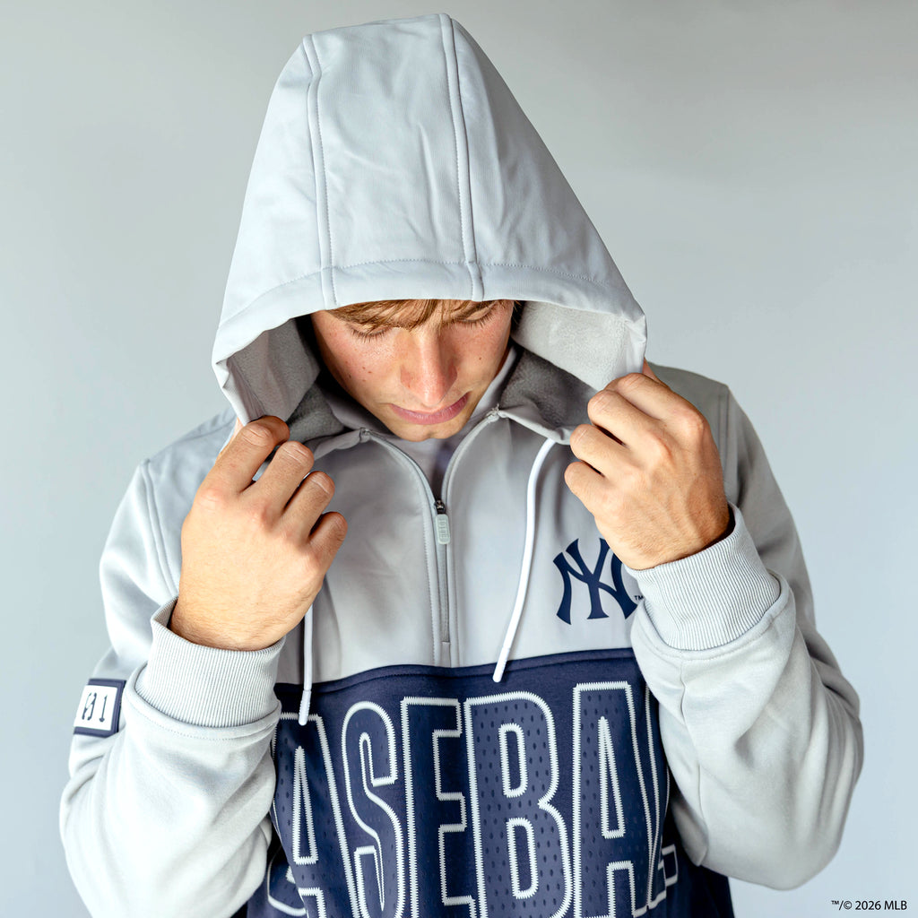 Adult model wearing navy New York Yankees Color Block quarter zip