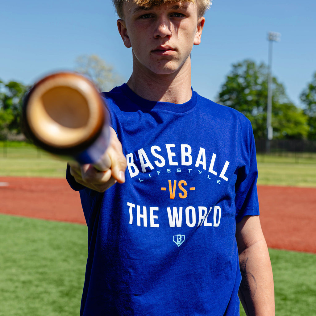 Adult model wearing navy graphic tee with "BL101 Vs The World" design